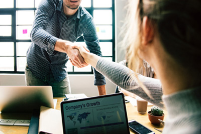 image of happy client shaking hands with staff member